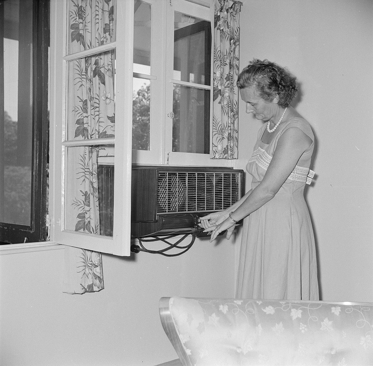 Woman installing air conditioner like a chump